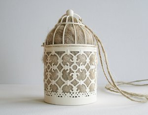 Bird Nester full of llama fibre for native birds. Small Moroccan style outdoor lantern for garden with natural nesting material