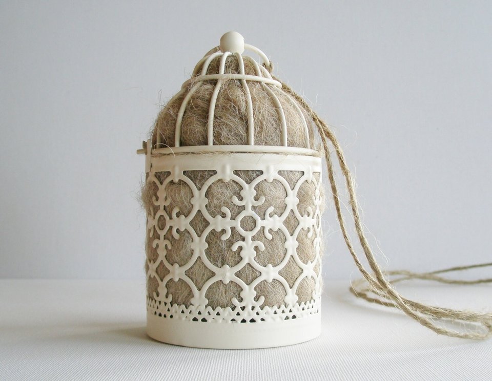 Bird Nester full of llama fibre for native birds. Small Moroccan style outdoor lantern for garden with natural nesting material