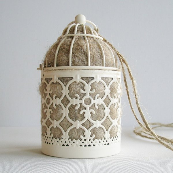Bird Nester full of llama fibre for native birds. Small Moroccan style outdoor lantern for garden with natural nesting material